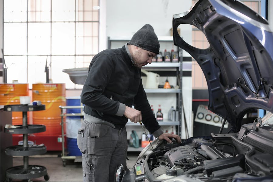 a mechanic looking at a car's engine bay